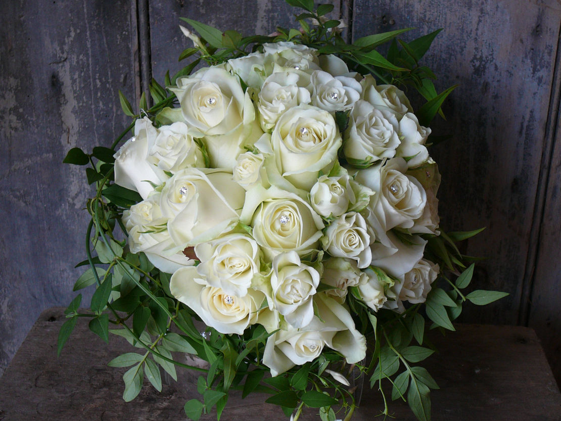 Classic hand-tied bouquet of all ivory roses